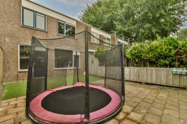 Neat powerful patio with sitting area and small garden near wooden fence