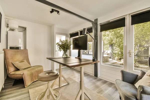 stock image Interior of light home office with desk and shelf rack near window with blinds