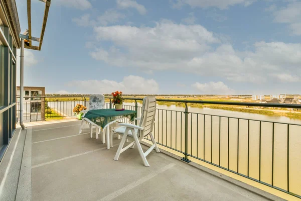 stock image Sitting area in balcony with comfortable furniture around beautiful view