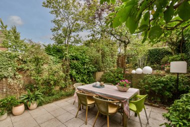 Neat powerful patio with sitting area and small garden