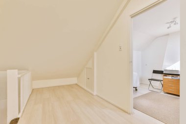 Modern apartmandaki hafif iş yerinde bilgisayar monitörleri ve beyaz tahtanın olduğu masanın yanına konforlu sandalye