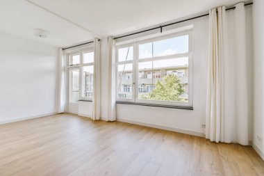 Interior of empty white kitchen with windows and wooden parquet floor