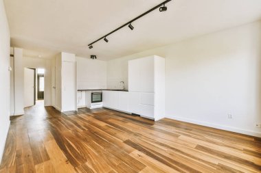 Interior of empty white kitchen with windows and wooden parquet floor