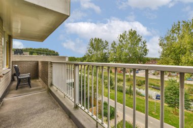 Panoramic view of old brick buildings with trees from small balcony