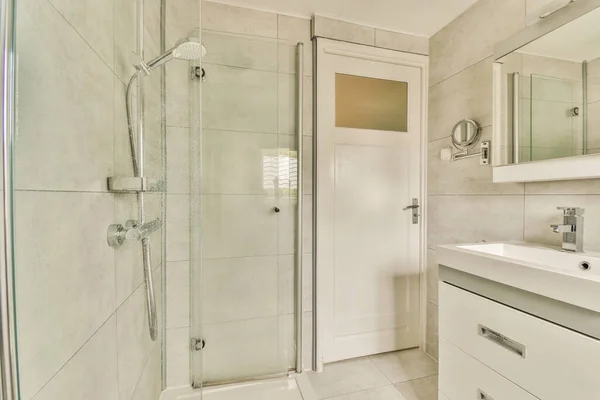 stock image Glass partition between shower tap and wall hung toilet in modern restroom at home