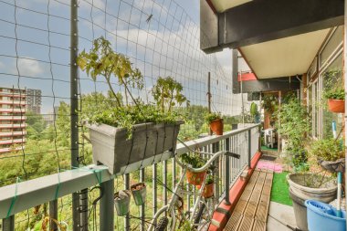 Panoramic view of old brick buildings with parking and trees from small balcony