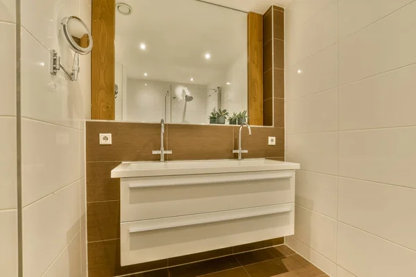 stock image Glass partition between shower tap and wall hung toilet in modern restroom at home