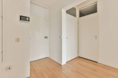 Light narrow hallway with many doors in white walls and glowing lamp over parquet floor