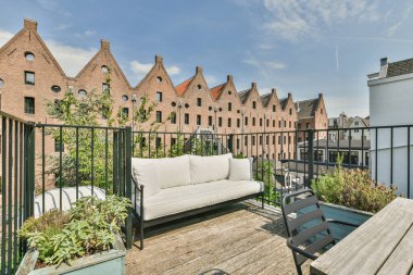 Panoramic view of buildings with trees from small balcony