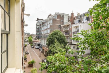 Panoramic view of buildings with trees from small balcony