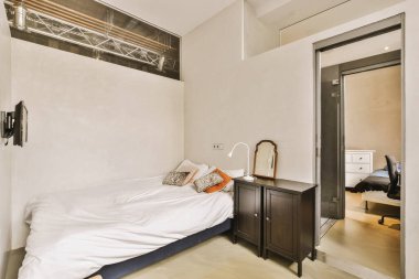 Yatak odasının iç tasarımı, yatak odası ve ahşap gardırop modern dairenin penceresinin kenarına yerleştirilmiş.