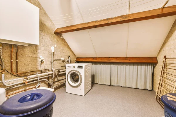 a laundry room with a washer, dryer and washing machine on the floor in front of the window