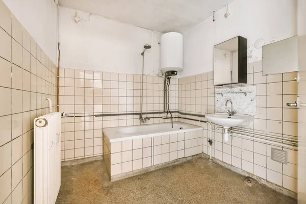 stock image a bathroom with white tiles on the walls, and a bathtub in the corner next to the shower stall