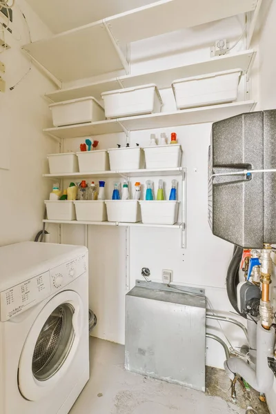 a laundry room with a washer, dryer and other items on the floor in front of the washing machine