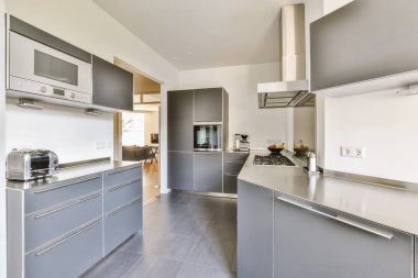 a modern kitchen with grey cabinets and stainless appliances on the counter tops in this photo is taken from the inside