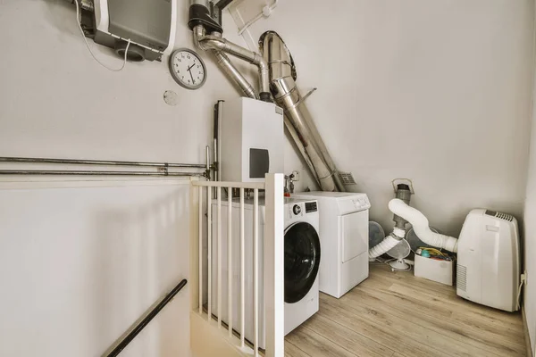 a laundry room with a washer, dryer and other items on the floor in front of the washing machine