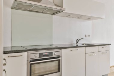 a modern kitchen with white cabinets and stainless appliances on the counter top in this photo is taken from the inside