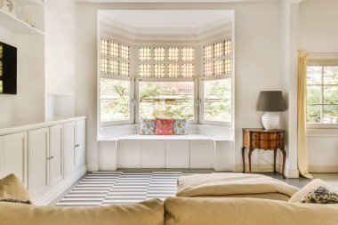 a living room with two couches and a television set in the corner of the room is shown on the wall
