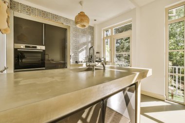 a kitchen area with an oven and sink in the center of the room, which is open to the outside