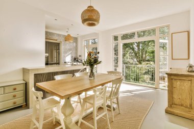 a kitchen and dining area in a house with sliding glass doors that open onto the patio to an outdoor deck