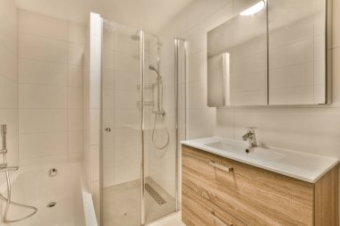 a bathroom with a sink, mirror and shower stall in the same color as it appears on the wall or floor