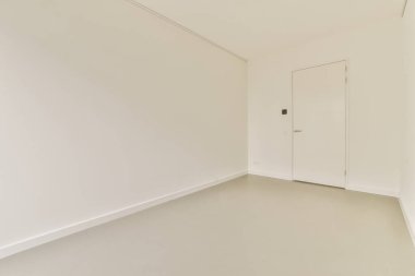 an empty room with white walls and no one person standing in the corner, or waiting area for someone to come