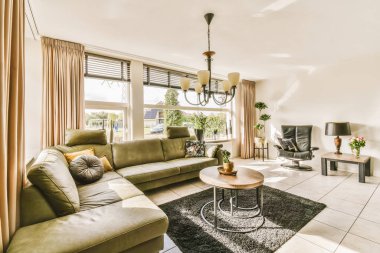 Oturma odası, iki kanepe ve pencerenin önünde bir sehpa, sokağa bakıyor.