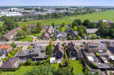 Amsterdam, Netherlands - 10 April, 2021: a house in the middle of a park with lots of leaves on the ground and trees lining the path leading up to it