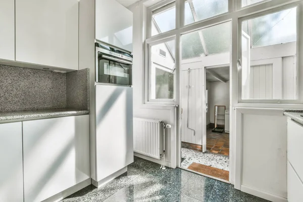 Granit Tezgahlı Boş Bir Mutfak Her Iki Tarafında Beyaz Dolaplar — Stok fotoğraf