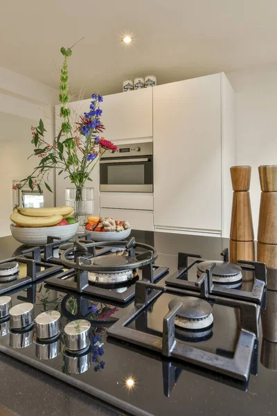 stock image a kitchen with pots and pans on the stove top, in front of an open white cabinetd door