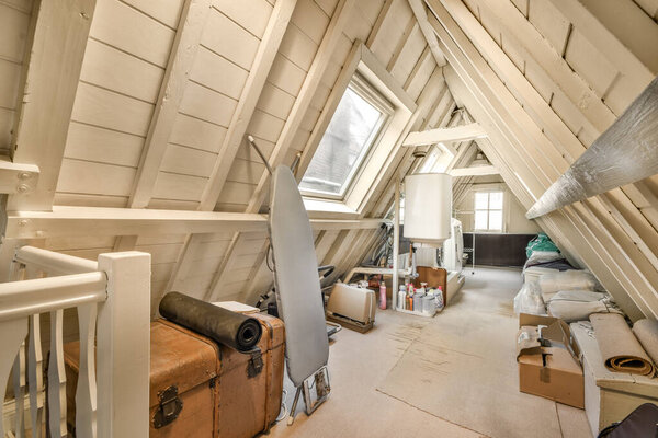 an attic with wood sidings on the walls and flooring boards all over the entire space, as well