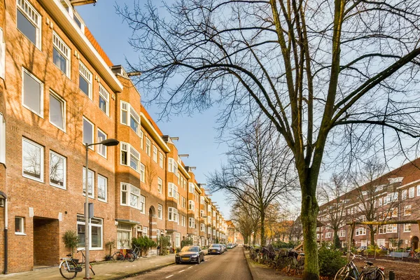 stock image a city street with bicycles parked on the side of the road and buildings in the back ground, all bricked up