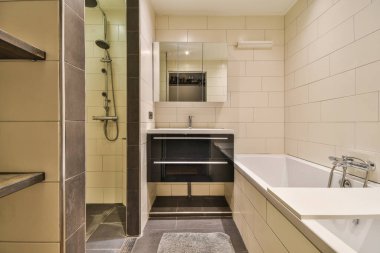a bathroom with a sink, mirror and bathtub next to the tub in this photo is taken from above