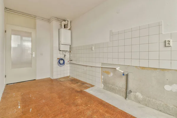 stock image an unfinished bathroom with white tiles on the walls and wood flooring in front of the door to the room