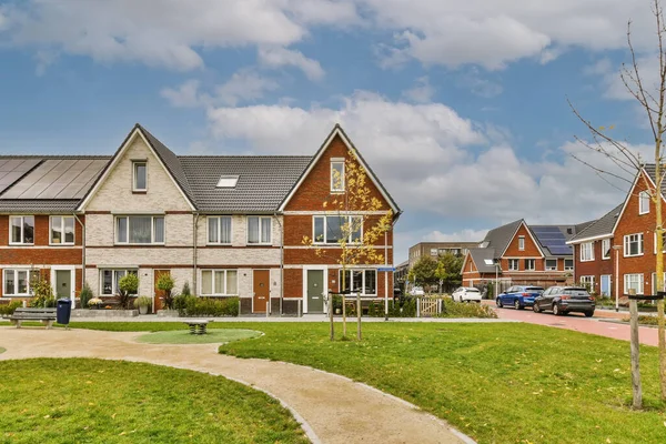 stock image some houses on a sunny day with blue sky and white clouds in the background photo is taken from an angleers perspective