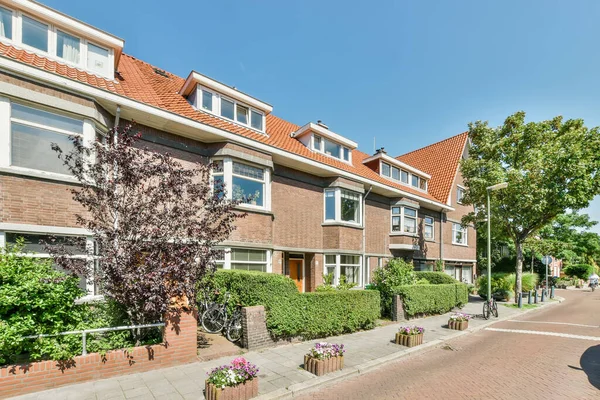 stock image Amsterdam, Netherlands - 10 April, 2021: a street with houses and trees in the middle part of amsterdam, netherlands photo taken on april 29, 2014