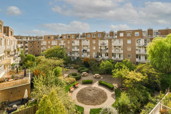 stock image Amsterdam, Netherlands - 10 April, 2021: an urban area with trees and buildings in the background, taken from a high angle on a clear blue sky day