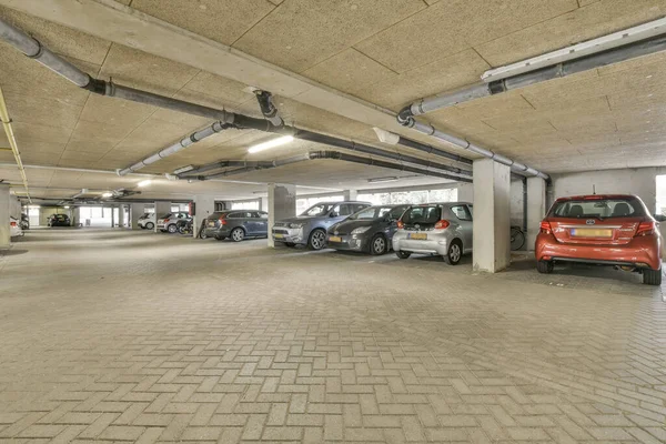 stock image several cars parked in a parking lot with no one on the ground, and there is an empty space for them to park