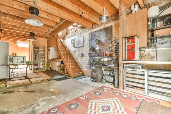 stock image Amsterdam, Netherlands - 10 April, 2021: a kitchen and living room in an old house with exposed ceilings, wood paneled walls, hardwood flooring, and lots of