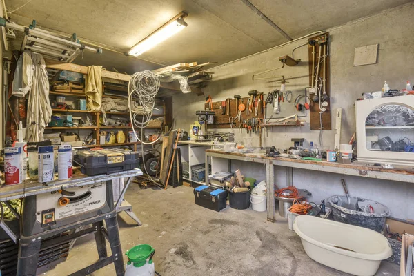 stock image Amsterdam, Netherlands - 10 April, 2021: a garage full of clutter and things that are not in use, but there is no room for the tools