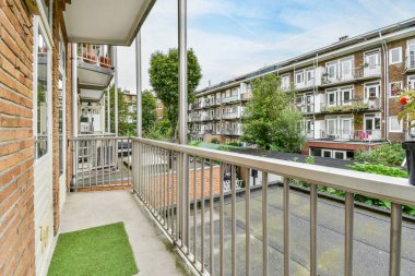 Amsterdam, Hollanda - 10 Nisan 2021: Arka planda bazı binalar ve binanın diğer tarafında yeşil çimenler olan bir dış alan çok temiz.