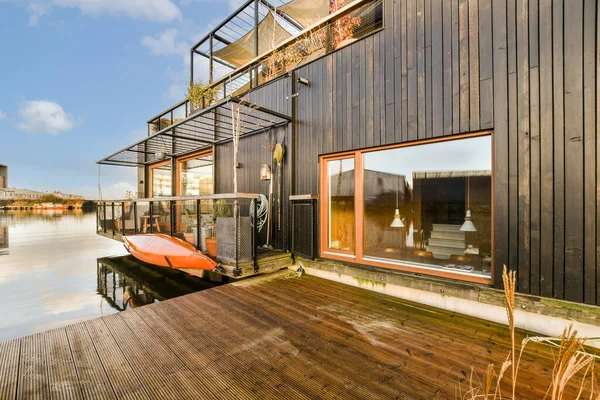 stock image a boat docked in the water near a building with a sign on its side that says, i love you