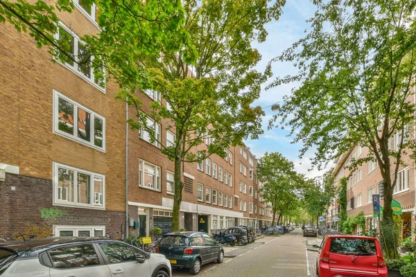 Amsterdam Holandia Kwietnia 2021 Ulica Miejska Samochodami Zaparkowanymi Boku Drzewami — Zdjęcie stockowe
