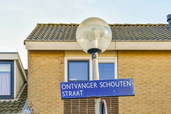 stock image a street sign in front of a brick building with the words on it and an image of a lamp post