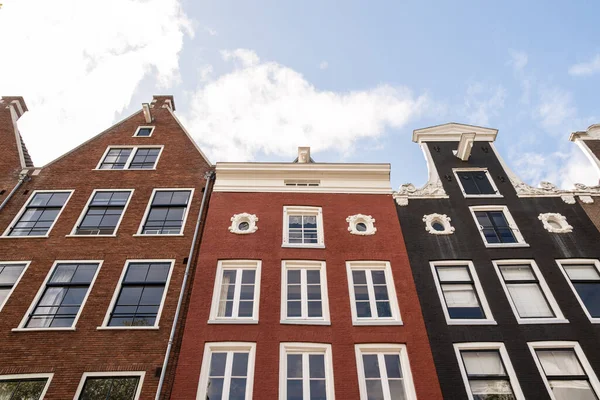 stock image Amsterdam, Netherlands - 10 April, 2021: some buildings that look like they are in the same color and shape, but with white trim around windows on each side