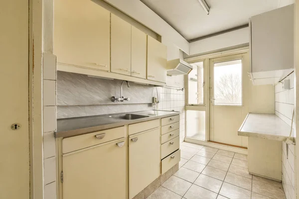 stock image an empty kitchen with no one in the room to be used for cooking, or as if its not