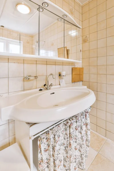 stock image a bathroom with a sink, mirror and toilet paper on the wall in this photo is taken from above it