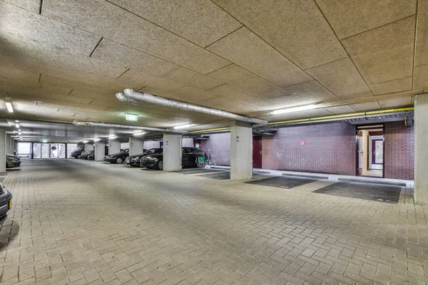 stock image an empty parking space with cars parked in the garages on either side of each other cars doors