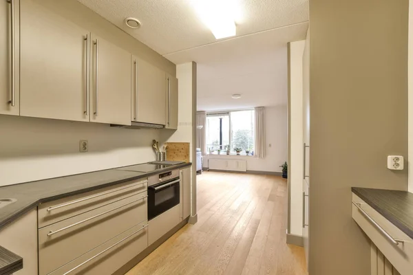 stock image a kitchen with wood floors and stainless appliances on the counters in front of the oven, sink and dishwasher