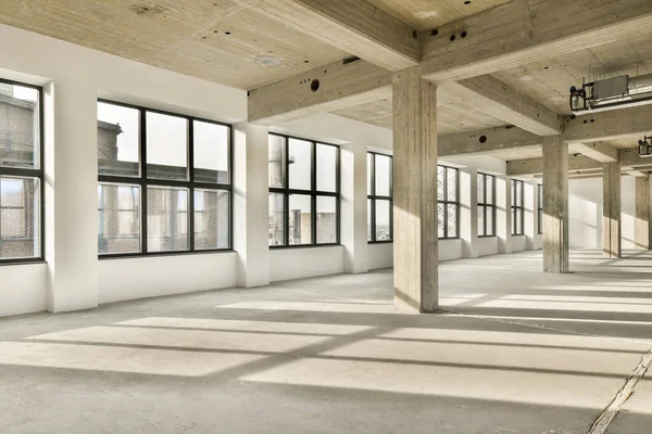 an empty building with windows and light coming in from the sun shining through the window panes on the floor